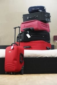 six suitcases stacked on top of each other