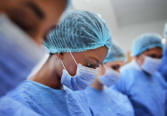 Cropped shot of a group of medical professionals performing surgery in the operating theatre
