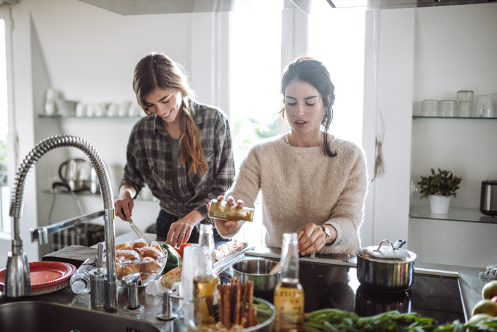 friends cooking together at home