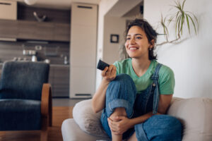 Girl enjoying her favorite TV show at home