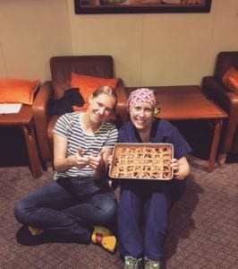 travel nurses holding a birthday pie while on assignment
