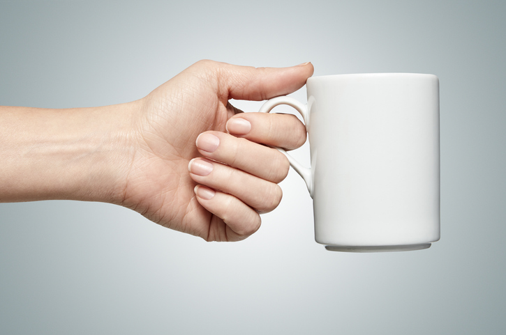 woman holding a white mug