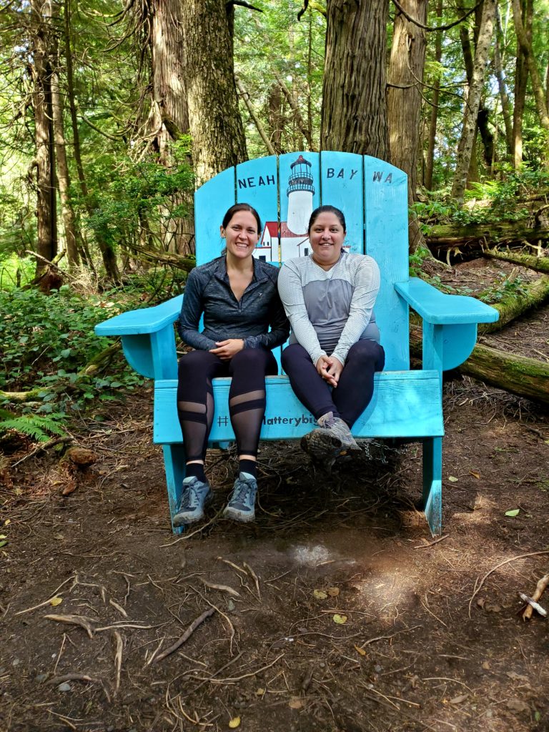 Anna and Kristy, travel nurses from TNAA and TotalMed, are just chilling together in a big chair somewhere in Washington state.