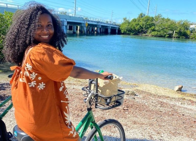 Andrissa, an allied traveler with TNAA and TotalMed, is relaxing on the beach after a nice bike ride.