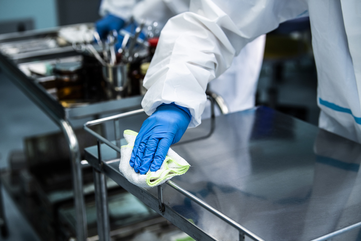 Surgeons cleaning instruments after surgery, infection control, covid-19