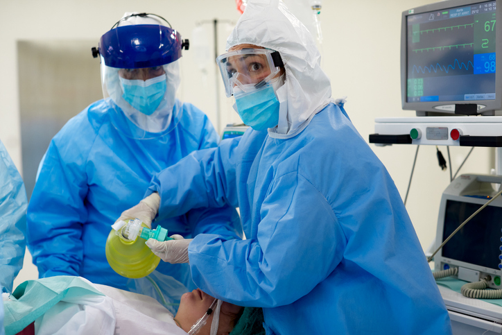 Emergency room, healthcare workers using a manual medical ventilator on a patient