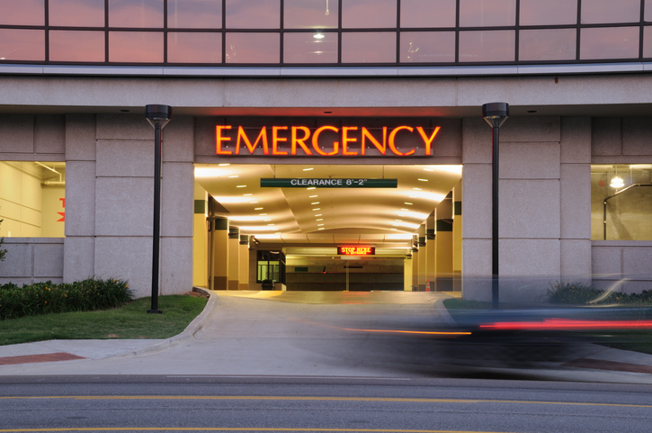Car entering emergency room at night