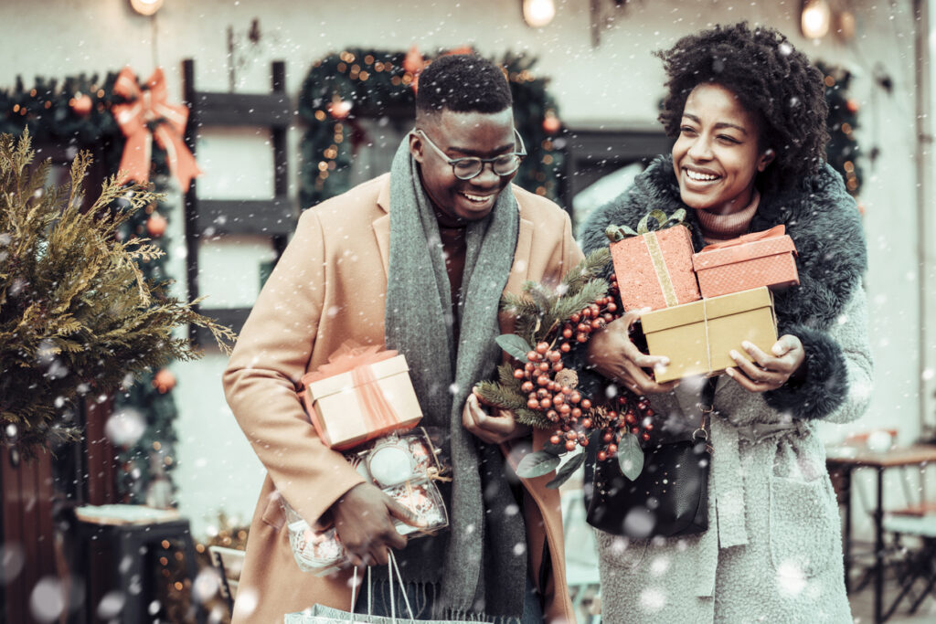 Young couple at Christmas shopping, holding Christmas present's