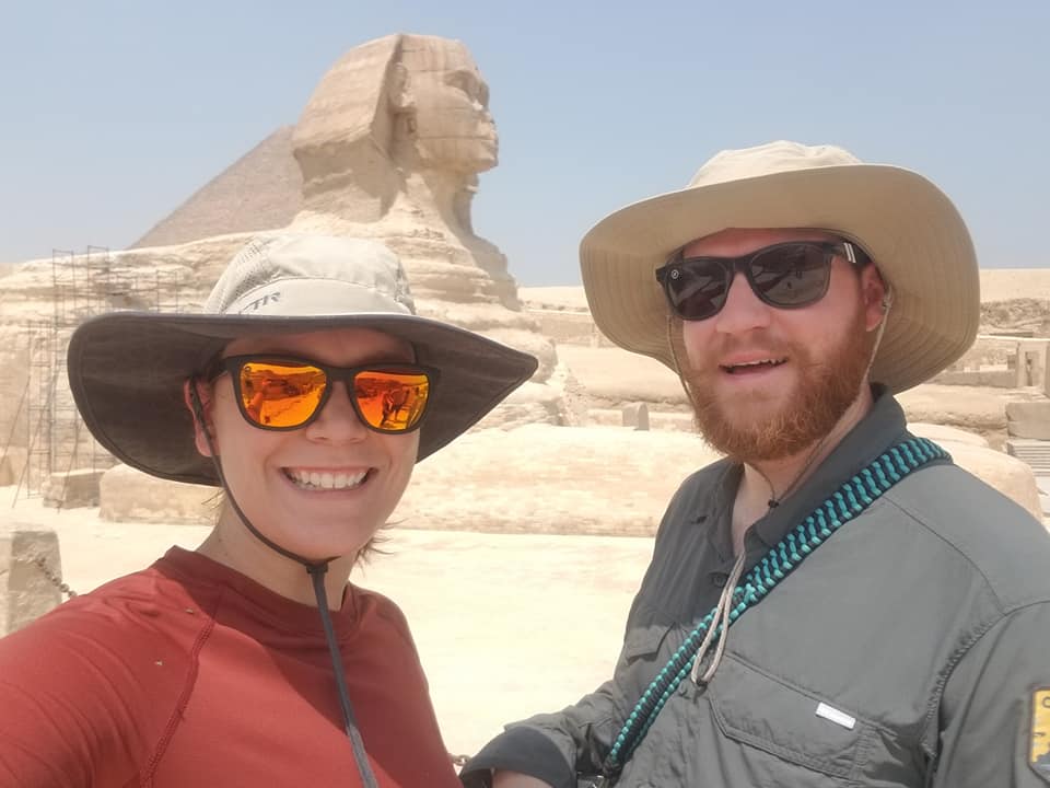 Travel nurses Zane and Ally posing in front of the Sphinx