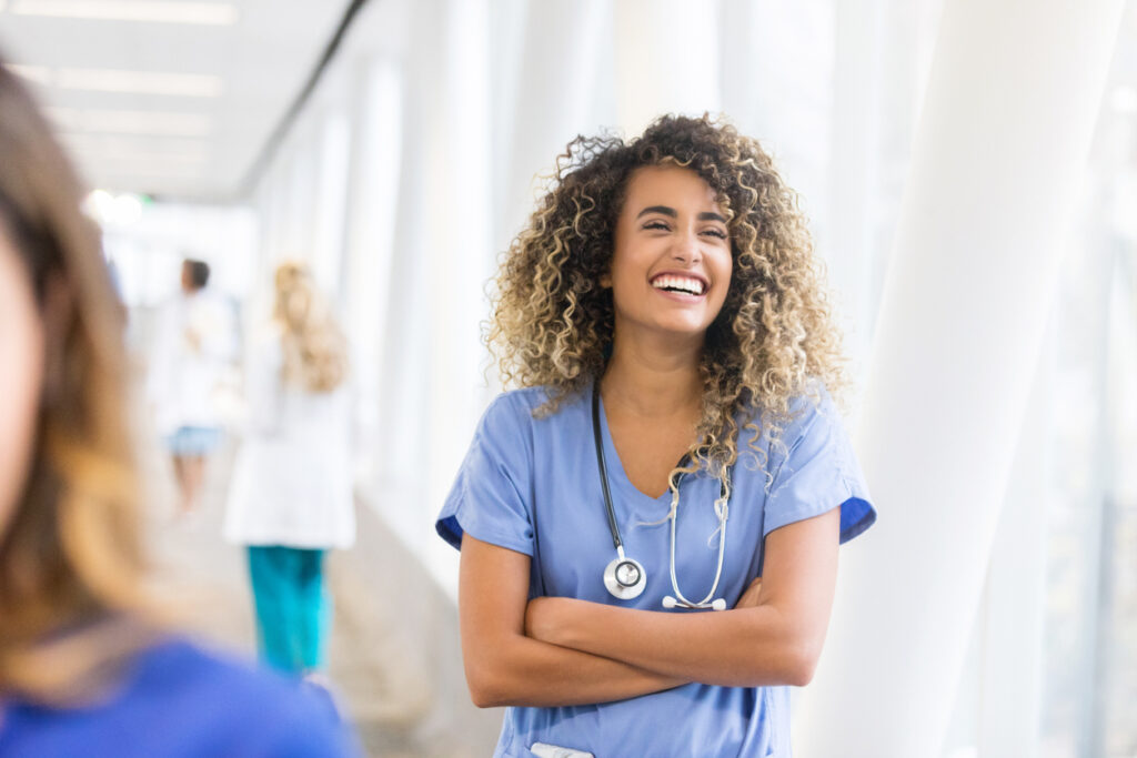 Cheerful nurse in hospital skybridge