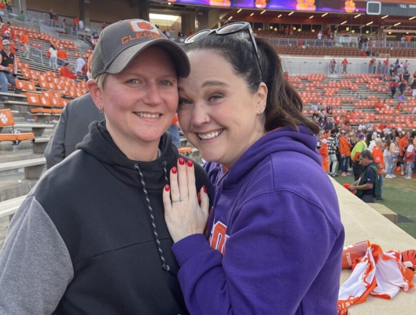 Engagement photo of Olivia and Christy at game