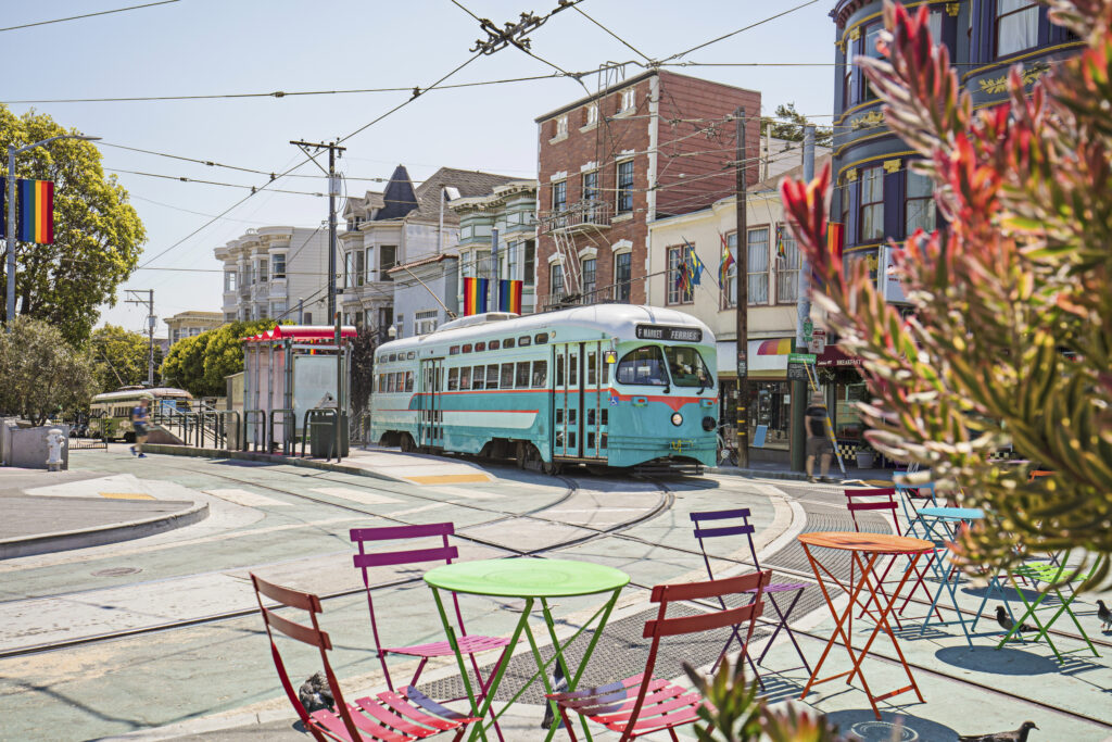 Streetcar in San Francisco’s Castro District with Pride flags, LGBTQ-friendly neighborhood with historic charm.