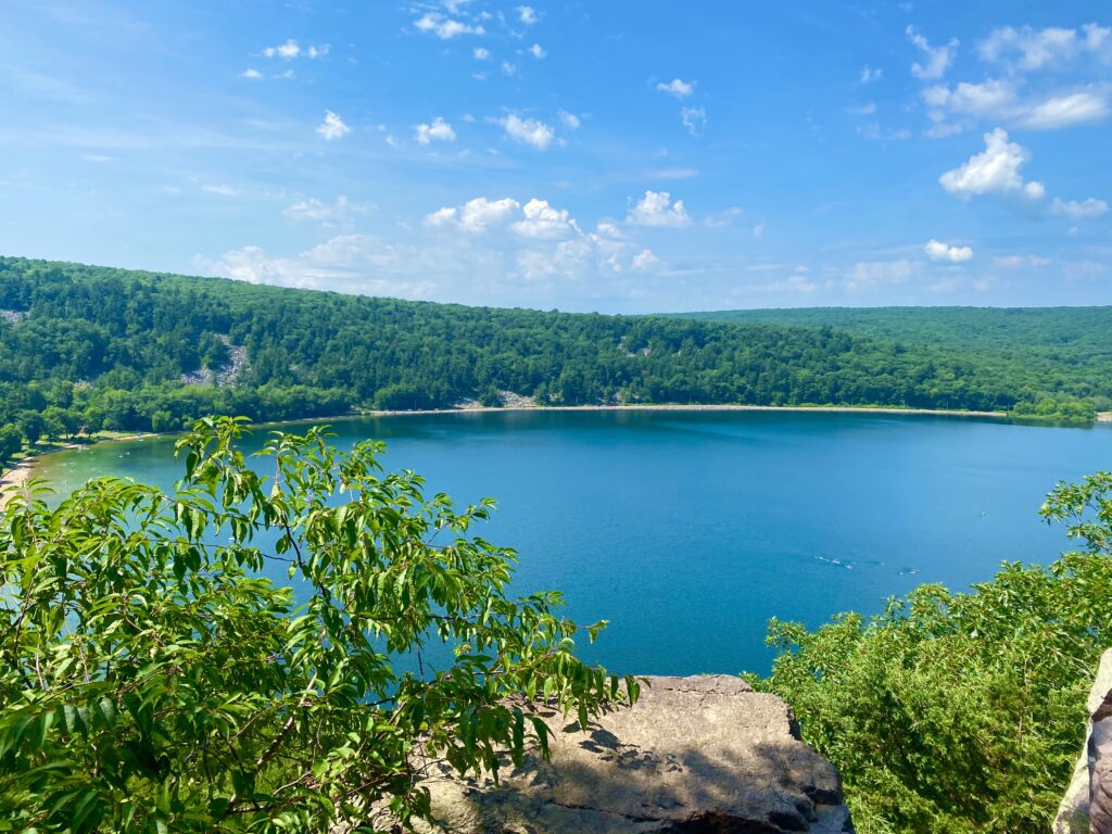 Devil’s Lake surrounded by quartzite bluffs and forested hiking trails in Wisconsin on a clear summer day