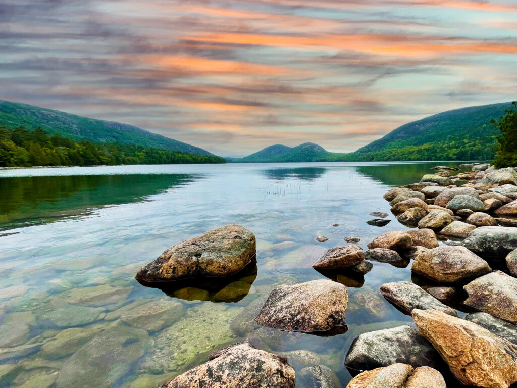 Clear waters of Jordan Pond with views of the Bubbles mountains in Acadia National Park, Maine on a sunny day