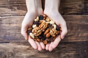 Open hands filled with granola.